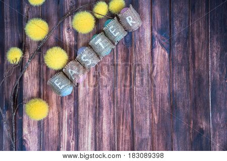 easter background with colored eggs yellow branches and copy space