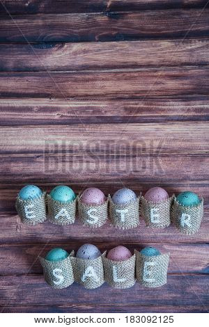 Easter concept: inscription Easter sale consisting on sacking. On wooden background waith copy space