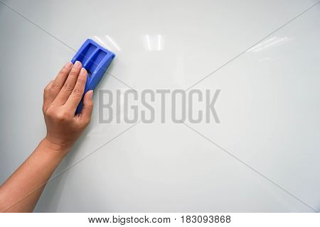 close up woman use eraser on mock up whiteboard