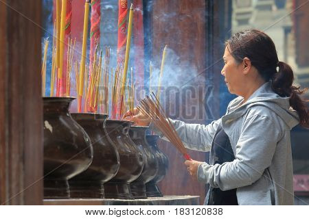 HO CHI MINH CITY VIETNAM - NOVEMBER 27, 2016: Unidentified woman pray at Thien Hau temple. Thien Hau temple is a Chinese style temple of the Chinese sea goddess Mazu in Chinatown.