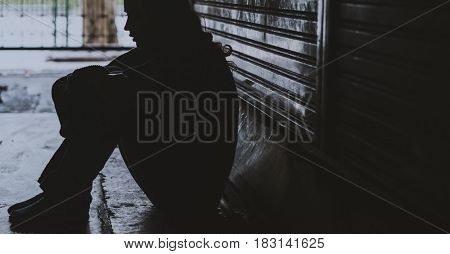Homeless Woman Sitting on The Street Side Hopeless
