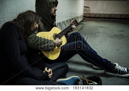 Homeless Couple Man Playing Guitar Asking For Money Donation
