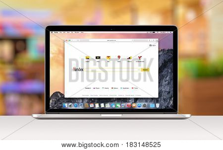 Yandex search web page in Safari browser on the Apple 15 inch MacBook Pro Retina screen. Blurred office space on the background: Varna, Bulgaria - November 03, 2013