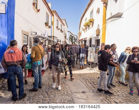 OBIDOS PORTUGAL - APRIL 02 2017: Crowd on the main street of Obidos during the chocolate festival 2017.