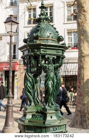 One of the drinking antique Wallace fountains with women group sculpture on in Paris
