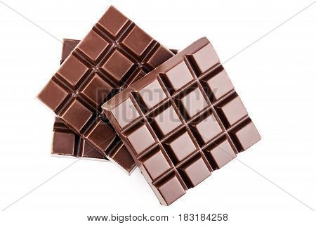 Three pieces of bitter dark chocolate bar isolated on white background close-up top view.