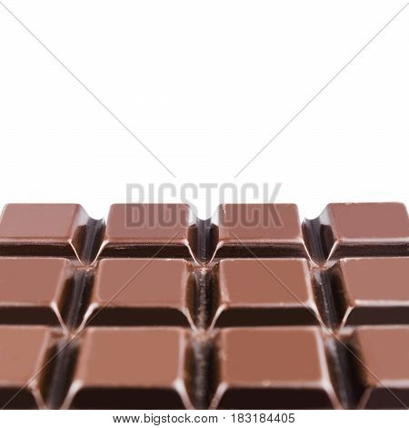 Bitter dark chocolate bar isolated on white background close-up view with copy space.