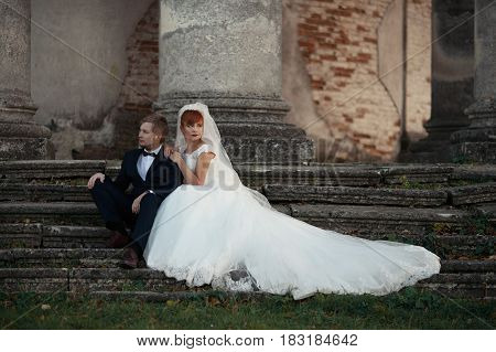 The Lovely Couple In Love Stand Near Coloums