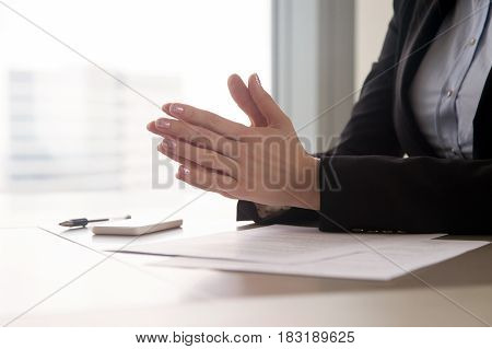 Close up view of female hands put together as in prayer in the office. Focused concentrated job applicant is nervous waiting for interview, businesswoman collecting thoughts before important meeting