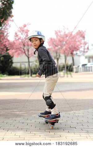 Japanese Boy Riding On A Casterboard (first Grade At Elementary School)