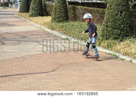 Japanese Boy Riding On A Casterboard (first Grade At Elementary School)