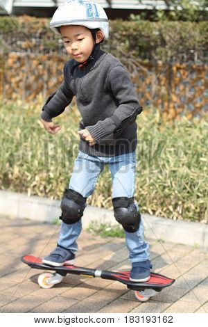 Japanese Boy Riding On A Casterboard (first Grade At Elementary School)