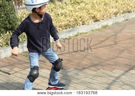 Japanese Boy Riding On A Casterboard (first Grade At Elementary School)