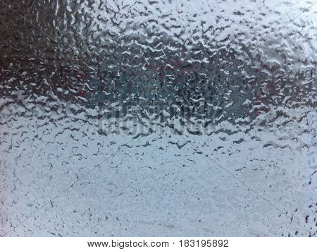 Winter glass. The frozen texture of the window. Ice on the window