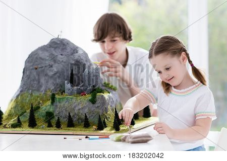 Kids Working On Model Building Project For School