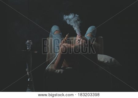 Sexy Girl With Naked Body Smoking Hookah In Jeans