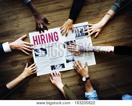 Diverse People Hands Reach Out for Hiring Newspaper Announcement