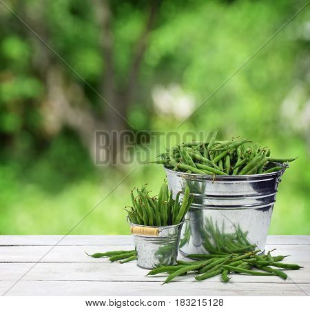 Green peas in the pods. Piles of fresh green peas in buckets. Concept. I like healthy food. Hobby. Organic food is my choice.