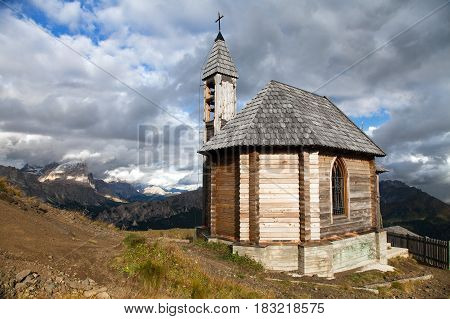 Small wooden church or chapel on the mountain top Col di Lana and Mount Civetta Alps Dolomites mountains Italy