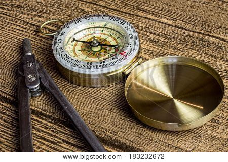 tourist compas and circinus on brown wooden table
