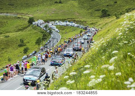Col de PeyresourdeFrance- July 23 2014: Row of technical cars climbing the road to Col de Peyresourde in Pyrenees Mountains during the stage 17 of Le Tour de France on 23 July 2014.