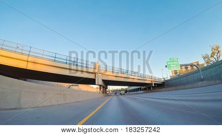 Denver Colorado USA-April 22 2017. POV point of view -Driving South in Interstate highway I25 at sunset.