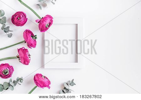 Modern spring design with bright pink flowers and frame on white desk background top view moke up