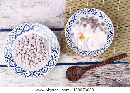 Purple Potato Dumplings With Poached Egg And Coconut Roll In Sweet Coconut Cream .