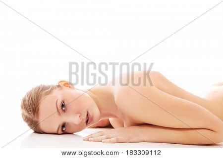 Nude woman lying on the floor