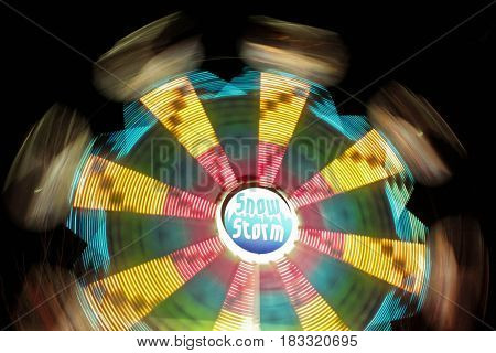 Ferris wheel moving at night time with dark sly