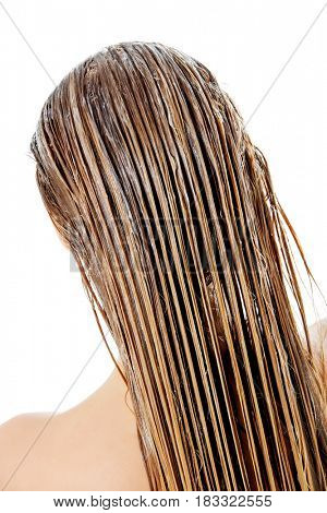Photo of woman applying hair conditioner.