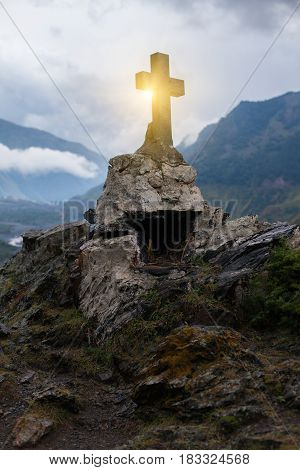GEORGIA KAZBEGI Orthodox cross near Caucasus mountains.