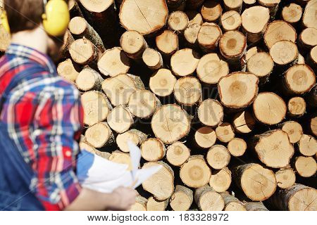 Stack of logs and lumber near by