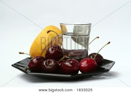 Cherries, Lemon And A Shot On A Plate