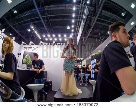 PhotoForum Moscow Russia Fujifilm Instax girl mini square business people exhibition crowd industry kiosk stall event photo video digital camera equipment product imaging pavilion stand spectator design marketing men women indoors booth customer sign grou