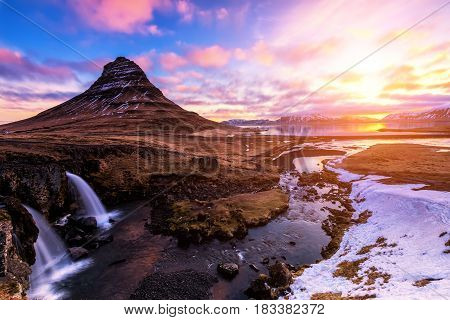 Spring Sunrise Over The Famous Kirkjufellsfoss Waterfall With Kirkjufell Mountain In The Background