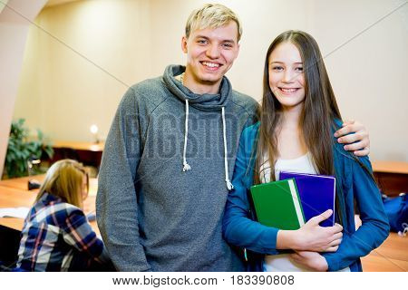 Portrait of two smiling college students on campus