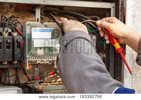 Repair of old electrical switchgear. An electrician replaces old electrical wiring devices