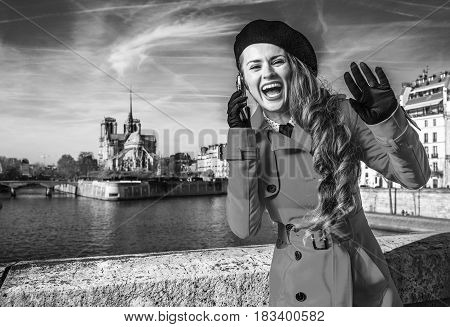 Woman On Embankment In Paris Talking On Cellphone And Handwaving