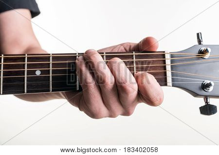 The Guitarist's Hand Clamps The Chord C On The Guitar, On A White Background. Horizontal Frame