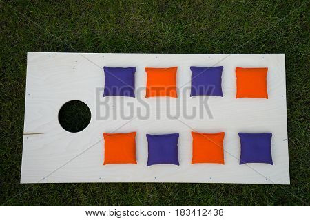 Cornhole Board Flat Lay with beanbags on grass