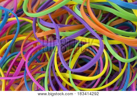 This is a photograph of a pile of Neon Colored elastic rubber bands