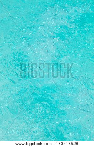 Clear background swimming pool rippled water detail.