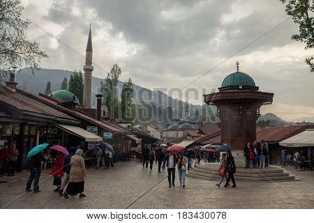 SARAJEVO BOSNIA HERZEGOVINA - APRIL 15 2017: Sebilj fountain on Bacarsija district in the afternoon. This fountain is considered to be one of the greatest landmarks of the Ottoman part of Sarajevo