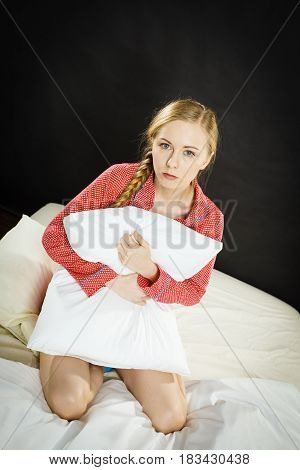 Sad Depressed Girl In Bed Gripping Pillow
