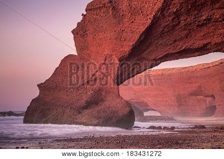 Sunset at red arches of Legzira beach, Sidi Ifni, Souss-Massa-Draa, Morocco.