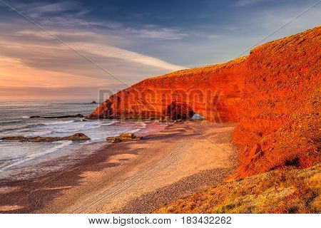 Sunset at red arches of Legzira beach, Sidi Ifni, Souss-Massa-Draa, Morocco.
