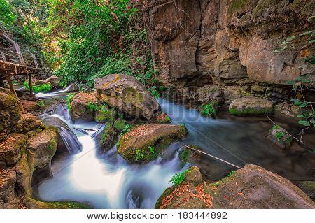 Banias river at north of Israel, flowing over rocks, shot with long exposure technique.