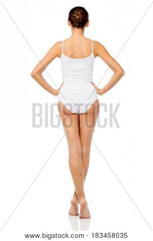beauty, people and bodycare concept - beautiful young woman in white underwear from back