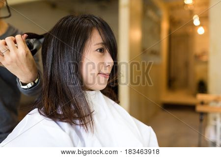 Woman having hir cut in salon